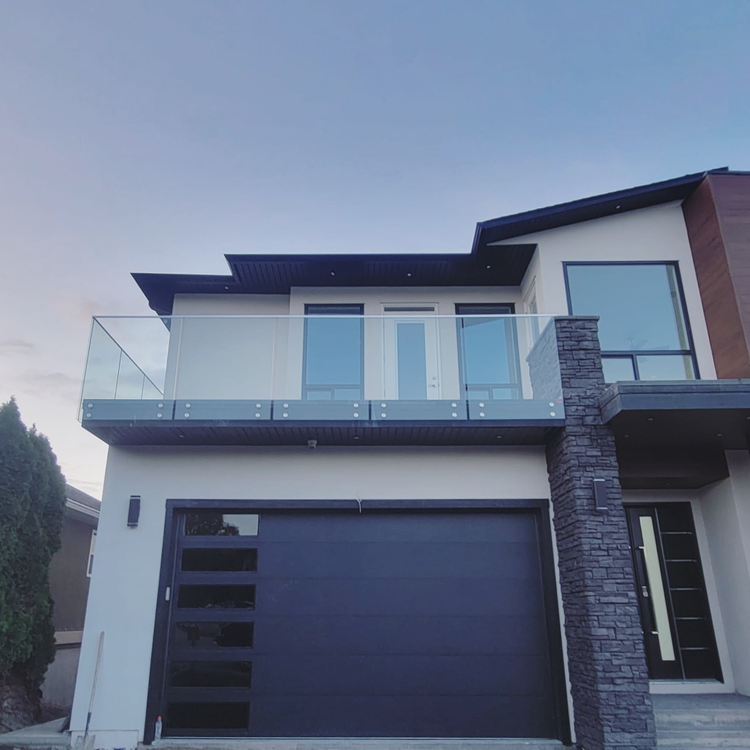 Modern black garage door repair and installation in Vernon